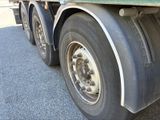 a truck with a flat tire parked on the side of the road