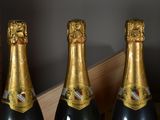 three bottles of champagne sitting on a table next to each other
