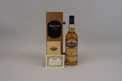 a bottle of whisky next to a cardboard box