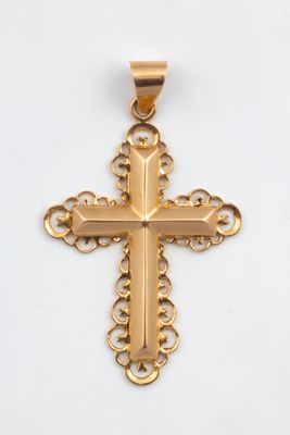 a gold cross pendant on a white background