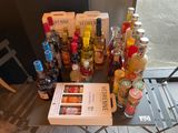 many bottles of alcohol sitting on a table next to a book
