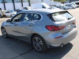 the back of a silver bmw car parked in a parking lot