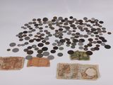 a lot of coins and a note sitting on a table