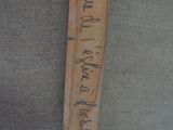 a wooden ruler that has writing on it