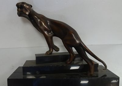 a bronze statue of a dog on a pedestal
