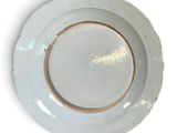 a white plate with a gold rim sitting on a white surface