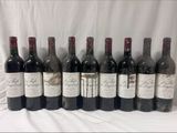several bottles of wine are lined up on a table