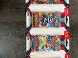 three packs of pokemon trading cards are on display in a box
