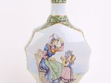 a vase with a picture of a man and a woman sitting at a table