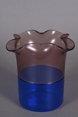 a blue and pink vase sitting on a table