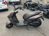 a scooter parked in a parking lot next to other scooters