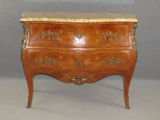 a small chest of drawers with a marble top