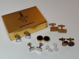 an image of a gold box with a pair of cufflinks and a pair of cufflinks