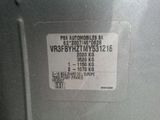 a sticker on the back of a silver refrigerator