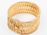 a close up of a gold bracelet on a white surface