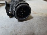 a close up of a black electrical plug on a table