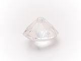 a close up of a white diamond on a white surface