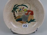 a small plate with a picture of a man and a dog on it