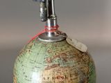 a green globe with a red string around it