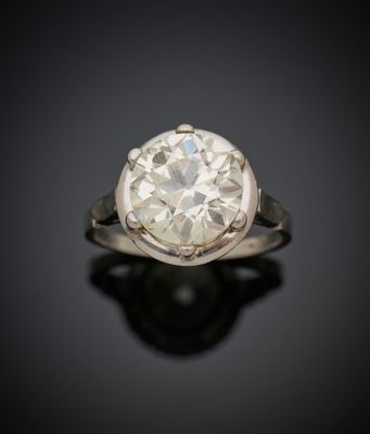 une vieille bague sertie d'un diamant taillé, posée sur une surface noire