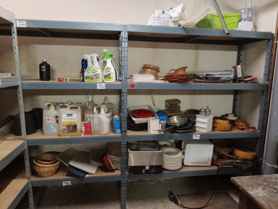 many shelves with various items on them in a room