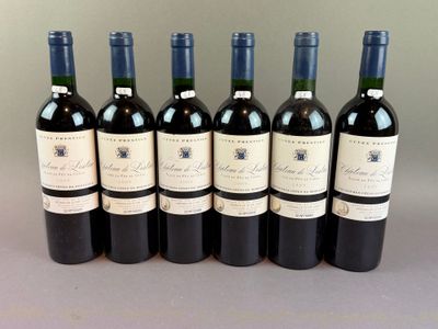 six bottles of wine are lined up in a row on a table