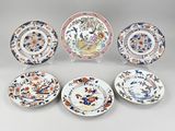 six plates with different designs on them sitting on a table