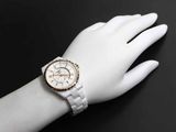 a woman ' s wrist that has a watch on it