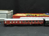 a toy train that is sitting on a table next to a box