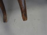 a wooden chair that has a wooden seat on it