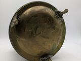 an antique brass plate with a handle on a white background
