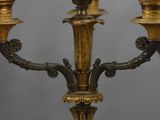 brass candelabra with three candles and a bird on the top