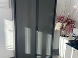 a black and white cabinet in the corner of a room
