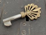 a metal key sitting on top of a wooden box