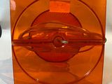 an orange glass box with a lid on a white surface