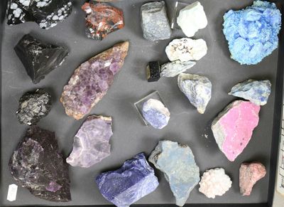 a black tray with a variety of rocks on it