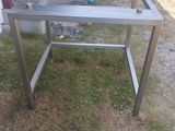 a metal table with a glass top in the yard