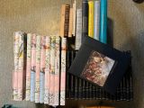 a lot of books on a shelf next to a clock