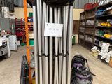 a stack of metal pipes in a warehouse with a sign on it