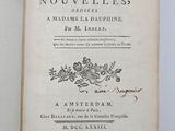 an open book with a black and white image of flowers on it