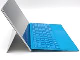 a laptop with a blue keyboard sitting on top of it