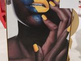 une image représentant une femme aux ongles jaunes et avec une lèvre bleue dessinée sur le visage