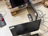 two monitors and a keyboard on a pallet in a room