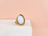 a white stone ring sitting on top of a marble block
