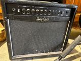 a guitar amp sitting on the floor next to a microphone