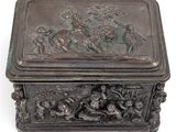 an antique bronze box with a scene of a man and a woman on horseback