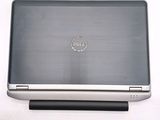 dell laptop computer sitting on top of a white surface