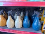 several spray bottles are lined up on a shelf in a store