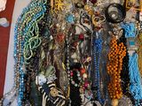 a pile of assorted necklaces and bracelets on a table