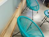 three chairs that are sitting in front of a window